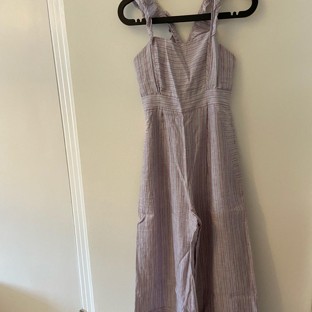 Anthropologie linen wide leg jumpsuit. Straps cross at the back.